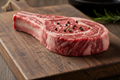 Raw Bone-In Ribeye on Cutting Board